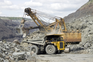 Mine worker with huge truck on the background